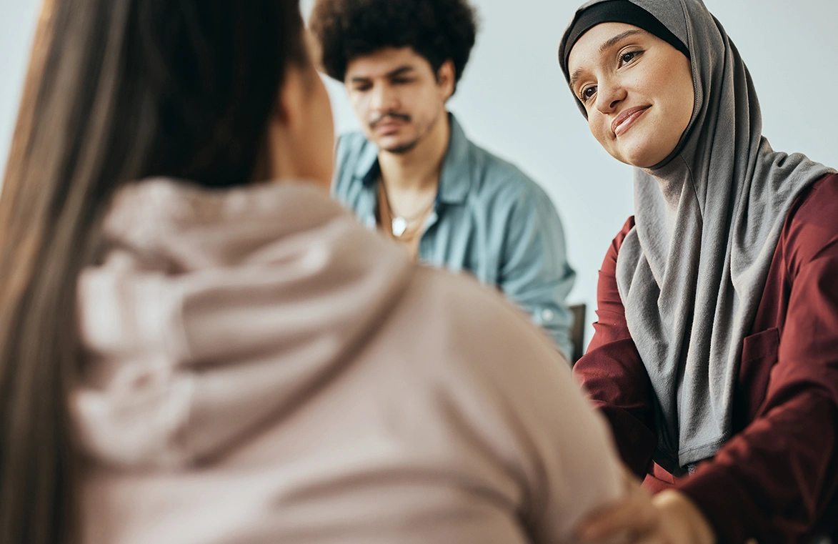 A group of young adults talking and listening to each other